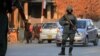 Afghan security officials stand guard at a roadside checkpoint on the outskirts of Ghazni on December 18.