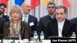 Abbas Araghchi (right), political deputy at the Iranian Foreign Ministry, and the secretary-general of the European Union External Action Service (EEAS), Helga Schmid, attend the Vienna meeting on February 26.