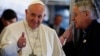 Turkey -- Pope Francis gives a thumbs up next to father Lombardi (R) during his flight to Turkey November 28, 2014. Pope Francis begins a visit to Turkey with the delicate mission of strengthening ties with Muslim leaders while condemning violence against