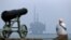 A member of the public stands on the shoreline looking out to sea, as Shell's Brent Delta Topside offshore oil drilling rig platform is towed by tug boats off the coast of Hartlepool, north-east England, on May 2, 2017, en route to Able Seaton Port for de