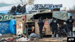 Authorities will begin dismantling makeshift shelters at the Calais camp by hand before sending in bulldozers to complete the job. (file photo)