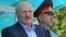 Belarusian ruler Alyaksandr Lukashenka (left) and Interior Minister Yury Karayeu (file photo)
