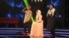 Afghan singer Zulala Hashemi (center) performs alongside competitors Sayed Jamal Mubarez (left) and Babak Mohammadi during the television music competition Afghan Star on March 9.