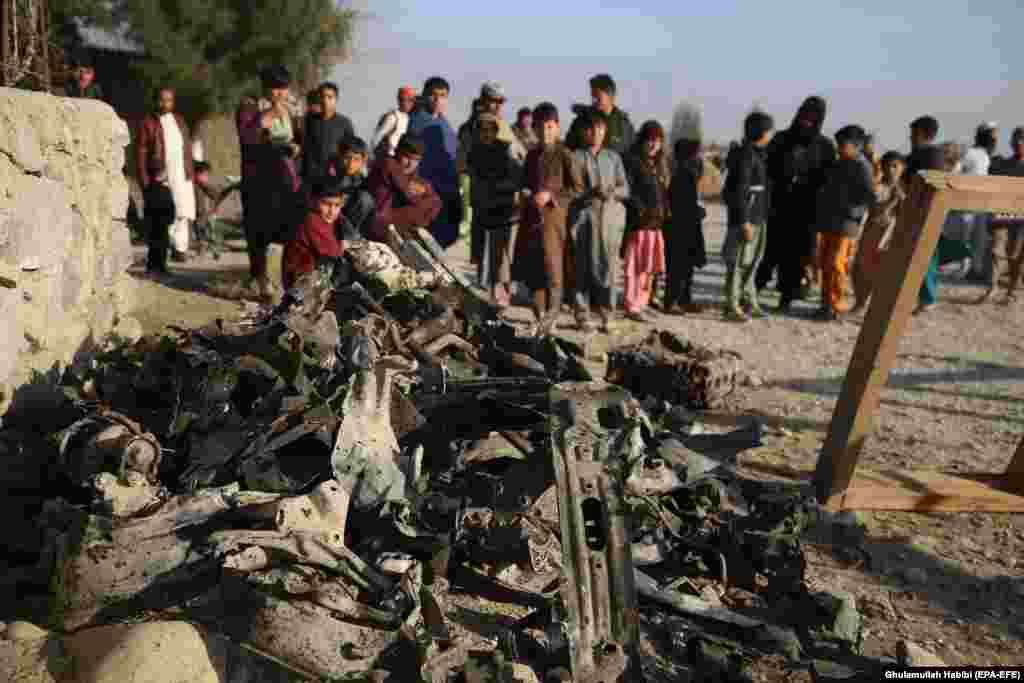 Local residents gather at the scene of a suicide car-bomb blast that targeted a police post on the outskirts of the Khogyani district of Afghanistan&#39;s eastern Nangarhar Province on February 7. (epa-EFE/Ghulamullah Habibi)