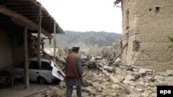 A local tribesman inspects a suspected militant hideout in North Waziristan after a recent air strike by a Pakistani war plane.