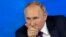 Russian President Vladimir Putin gesticulates during his annual news conference in Moscow on December 23.
