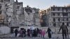 Syria -- Syrian residents fleeing the violence in the eastern rebel-held parts of Aleppo evacuate from their neighbourhoods through the Bab al-Hadid district after it was seized by the government forces, December 7, 2016