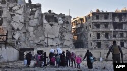 Syria -- Syrian residents fleeing the violence in the eastern rebel-held parts of Aleppo evacuate from their neighbourhoods through the Bab al-Hadid district after it was seized by the government forces, December 7, 2016