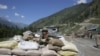 An Indian paramilitary soldier stands guard along a highway in Indian-controlled Kashmir. (file photo)