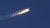 Turkey -- A still image made available on 24 November 2015 from video footage shown by the HaberTurk TV Channel shows a burning trail as a plane comes down after being shot down near the Turkish-Syrian border, over north Syria, 24 November 2015.