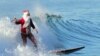 Surfing Santa Michael Pless, 61, catches a wave at Seal Beach, south of Los Angeles on December 24. (AFP/Frederic J. Brown)