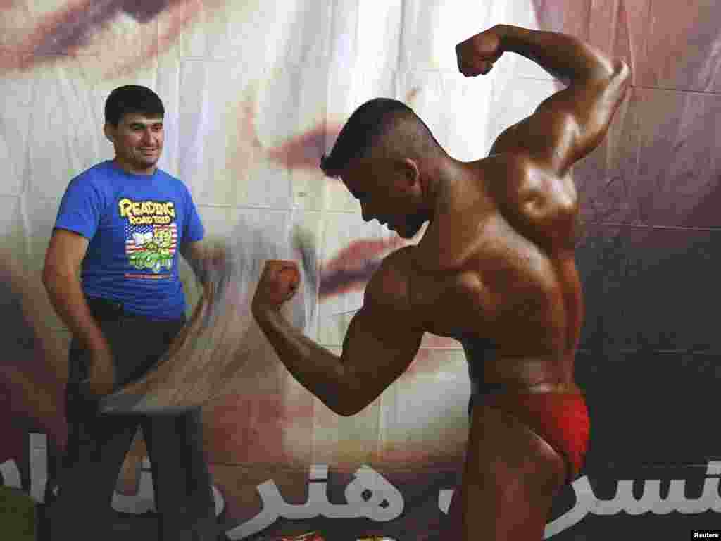 A man prepares for a bodybuilding competition in Kabul. Photo by Omar Sobhani for Reuters.