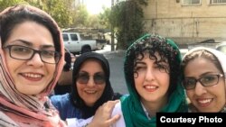 Narges Mohammadi (2nd from R), Iranian human rights activist, on a brief leave from prison greeted by other female activists. Sep 2018. FILE PHOTO