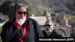 An Armenian woman cries as she visits for the last time a medieval monastery in Kalbajar before Armenian forces withdraw from the area adjacent to Nagorno-Karabakh on November 15