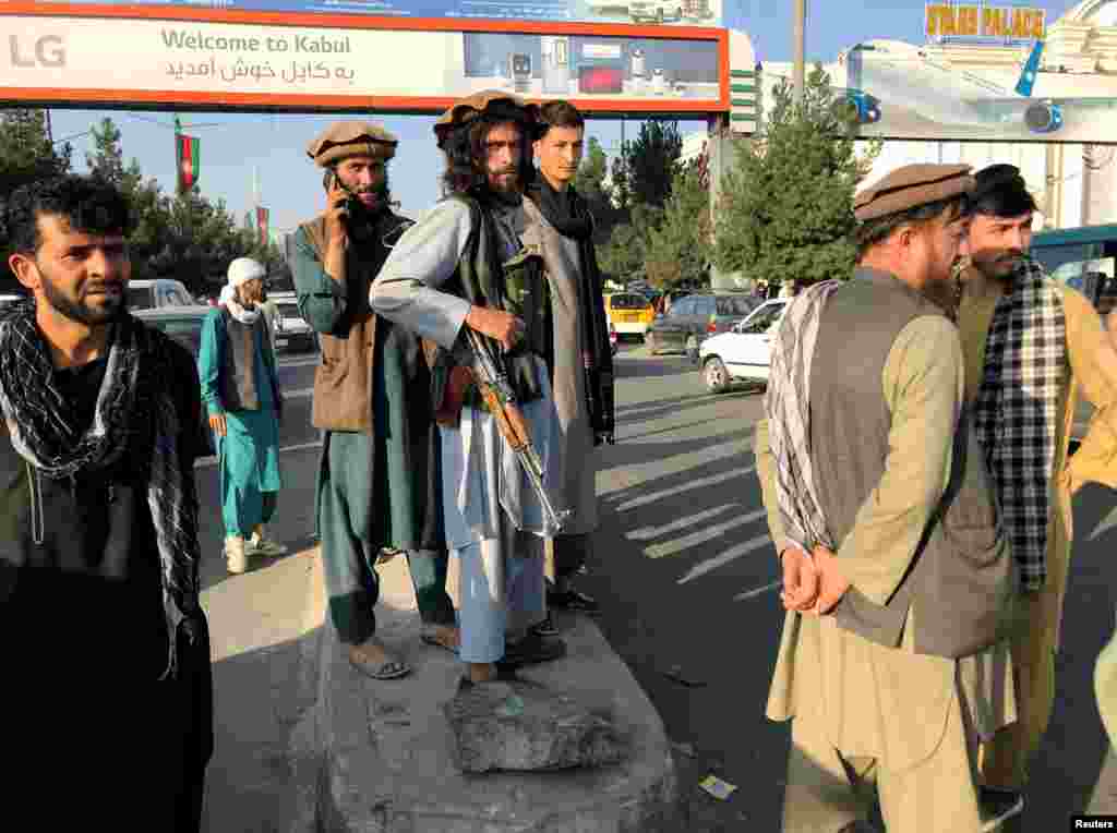 A Taliban fighter keeps watch outside Hamid Karzai International Airport on August 16.&nbsp;