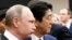 Russian President Vladimir Putin (left) with Japanese Prime Minister Shinzo Abe in Tokyo on December 16. 