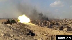 A Syrian Army tank fires during a battle against Islamic State militants in Deir al-Zor in Novemeber.