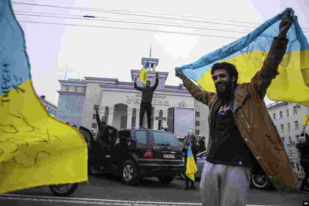 Жители на Херсон празнуват в центъра на града в събота, ден след като Украйна си върна контрола върху него. Херсон беше единствената областна столица, която руските сили успяха да превземат след началото на непредизвиканата си инвазия на 24 февруари.