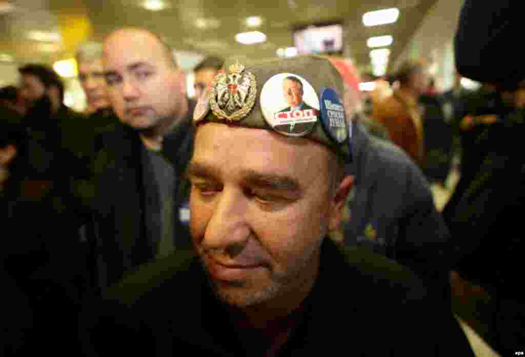 A supporter of Serbian nationalist Vojislav Seselj awaits his arrival at Nikola Tesla airport in Belgrade. (EPA/Koca Sulejmanovic)