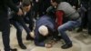 Serhiy Syvokho, an adviser to the secretary of the National Security and Defense Council, is helped up after he was push to the floor by a right-wing activist in Kyiv on March 12.