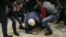 Serhiy Syvokho, an adviser to the secretary of the National Security and Defense Council, is helped up after he was push to the floor by a right-wing activist in Kyiv on March 12.