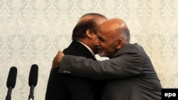 Pakistani Prime Minister Nawaz Sharif (left) and Afghan President Ashraf Ghani hug during Sharif's visit to Kabul on May 12.