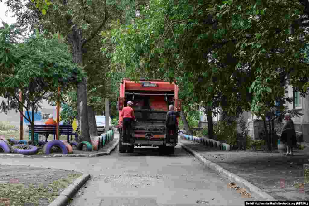 Municipal employees try to work in a city under fire.