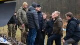 Polish Prime Minister Donald Tusk (second right) surveys damaged railway tracks on the Warsaw-Lublin line on November 17 after an explosion that he called an "unprecedented act of sabotage." 