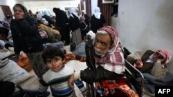 Iraqi Yazidis wait for medical assistance from doctors at Al-Tun Kopri health center, located halfway between the northern Iraqi city of Kirkuk and Irbil, in January.