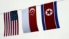 U.S., Singaporean, and North Korean flags decorate the entrance of a local bar in Singapore.