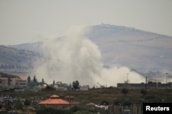 Smoke billows from southern Lebanon following an Israeli strike, as seen from Nabatieh, Lebanon, on June 13.