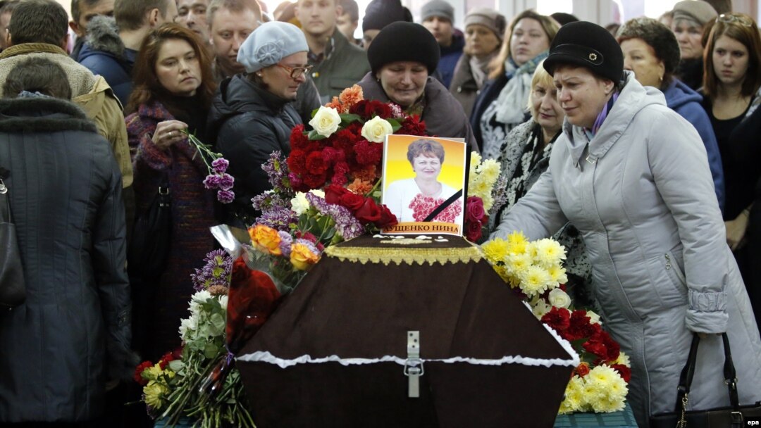Mourners grieve at the coffin of Nina Lushchenko, a victim of the Russian MetroJet Airbus A321 crash in Egypt, during her funeral service at a church in Veliky Novgorod on November 5. 