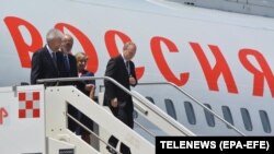 Russian President Vladimir Putin (right) arrives at Rome's international airport in Fiumicino on July 4.