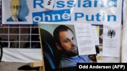 Плакат с портретом Зелимана Хангошвили на акции протеста против бездействия российского правительства. Германия, 2019 год