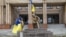 Ukrainian flags are displayed on a statue of Taras Shevchenko in the center of the city of Balaklia in the Kharkiv region after it was liberated from Russian forces.