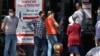 People stand in line outside a pharmacy in Almaty, Kazakhstan. In Almaty, customers at one pharmacy arrived to find long handwritten lists of all the medicines that were not available.