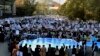 Muslim demonstrators hold banners as they shout slogans during a protest against French President Emmanuel Macron in Kabul on October 30.