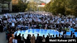 Muslim demonstrators hold banners as they shout slogans during a protest against French President Emmanuel Macron in Kabul on October 30.