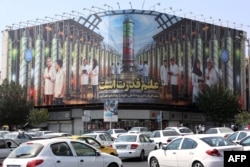 The Enqelab Square billboard depicting nuclear scientists and centrifuges with the slogan “science is power" in August 2025.