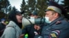 A woman argues with a police officer during a protest in support of jailed opposition leader Aleksei Navalny in Ulan-Ude, Russia. (AP/Anna Ogorodnik)