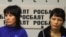 Bakiya Kasymova (left) and Leila Ashirova, both recently freed from what they describe as captivity, talk to reporters in Moscow on November 2.