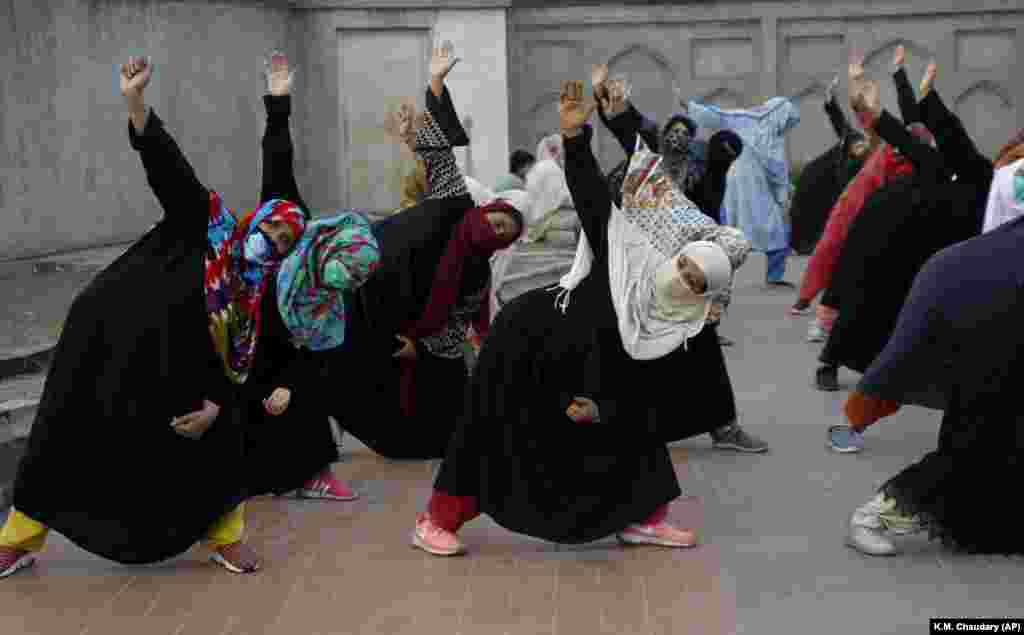 Women take part in a yoga session in Lahore, Pakistan.&nbsp;