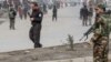 Afghan security forces stand guard after a gun attack in Kabul on March 6.