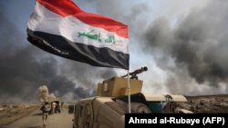 Iraqi forces hold a position as they advance toward the Islamic State group's stronghold of Hawija on September 30.