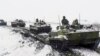 In a photo provided by the Russian Defense Ministry on January 26, Russian military vehicles participate in exercises at a training ground in the Rostov region near Ukraine.
