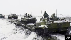 In a photo provided by the Russian Defense Ministry on January 26, Russian military vehicles participate in exercises at a training ground in the Rostov region near Ukraine.
