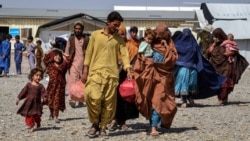 Afghan returnees carrying their belongings arrive from Pakistan at a registration center in the Takhta Pul district of Afghanistan's Kandahar Province. According to the United Nations, more than 2.6 million Afghans have returned home from Pakistan since a mass expulsion campaign began in 2023. (file photo)