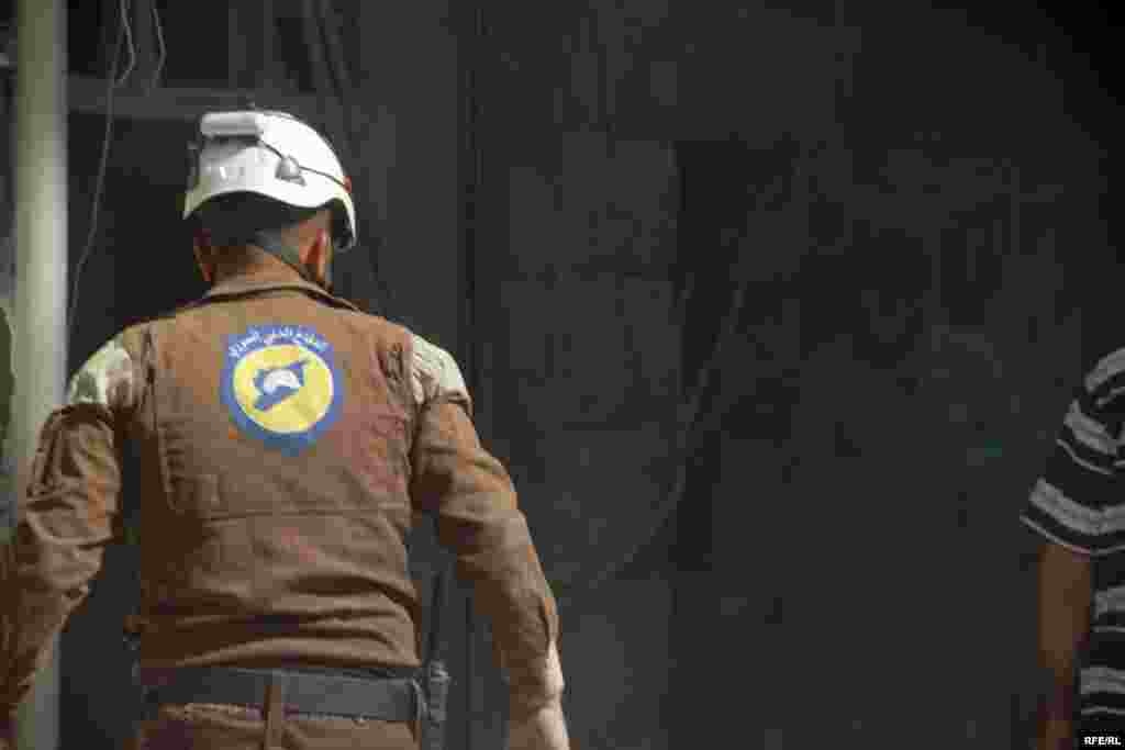 A rescue worker hunts for victims in a bombed-out building in Aleppo&#39;s Bustan&nbsp;al-Qasr district on October 11.&nbsp;The Syrian Observatory for Human Rights said at least 290 people, mostly civilians, have been killed by government or Russian air strikes since the operation to retake Aleppo began on September 22.