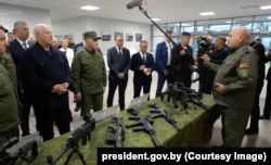 Belarusian leader Aleksandr Lukashenko (left) is shown small arms in a Kidma Tech facility on August 18.