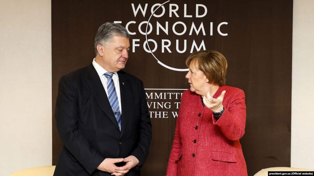 Президент України Петро Порошенко і канцлер Німеччини Анґела Меркель. Давос, 23 січня 2019 року